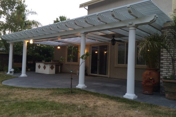 Daytime view of backyard patio with mixed lattice and solid roofing system installed in Fair Oaks, CA