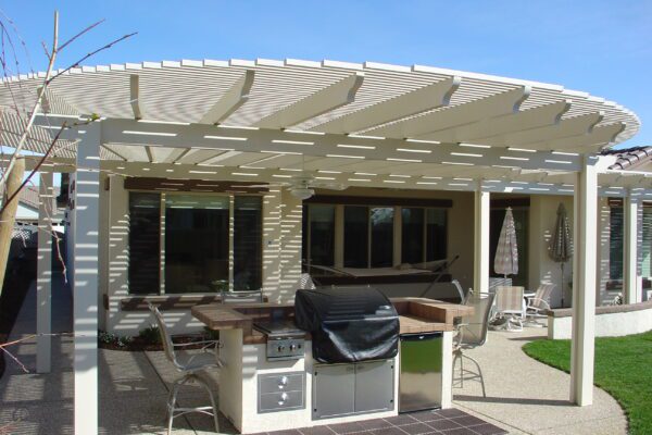 Family enjoying a backyard under a combination lattice and solid patio cover installed in Newcastle, CA
