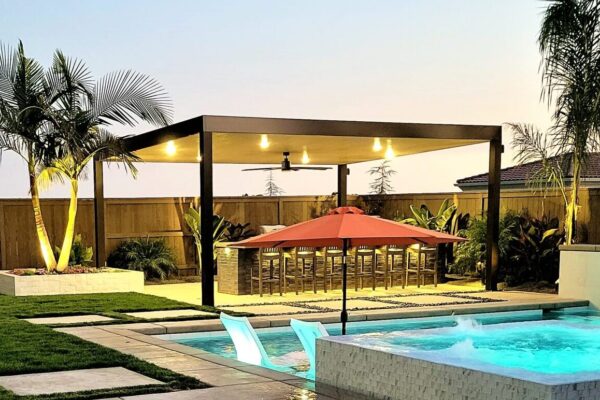 Solid aluminum patio cover providing full shade over backyard seating area installed in Sacramento, CA